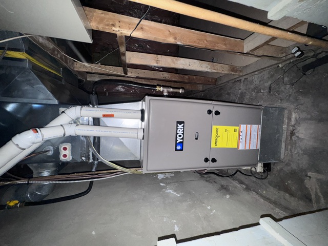 York furnace with connected ductwork and overhead vent piping
