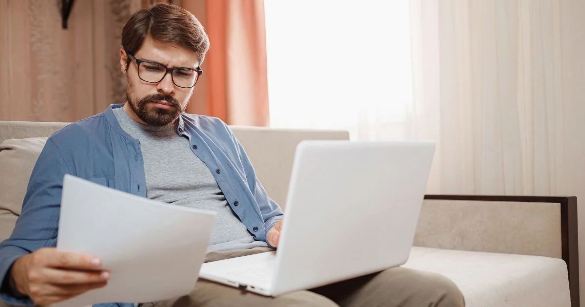 Homeowner reviewing heating bill on laptop
